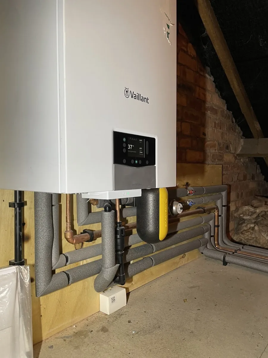Vaillant combi boiler installed by Andy Thomas Gas Services with insulated copper pipework and a magnetic filter