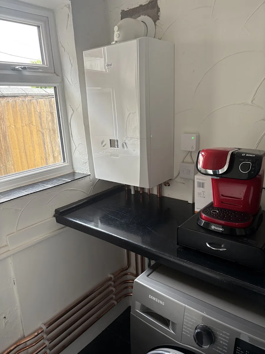 Ideal combi boiler installed by Andy Thomas Gas Services with tidy copper pipework in a utility room
